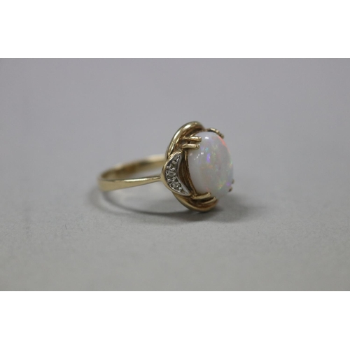 319 - 9ct gold and diamond, milky opal ring