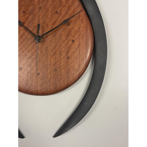 268 - Dave Jones, Grasp of time, Australian blue gum surround wall clock, approx 60cm H