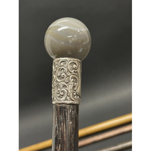 1022 - Four various walking sticks, comprising 1 with ivory handle, an agate and silver mounted stick dated... 