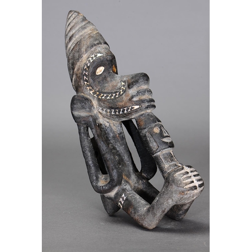 1123 - NGUZU NGUZU CANOE PROW ORNAMENT, SOLOMON ISLANDS. Carved and engraved wood, black dye, nautilus shel... 