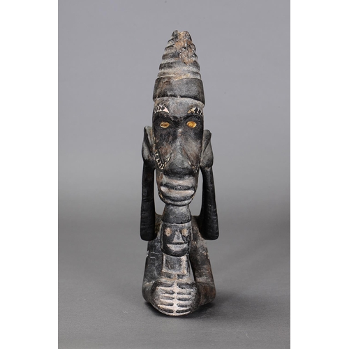 1123 - NGUZU NGUZU CANOE PROW ORNAMENT, SOLOMON ISLANDS. Carved and engraved wood, black dye, nautilus shel... 