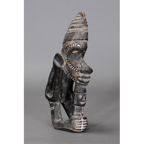 1123 - NGUZU NGUZU CANOE PROW ORNAMENT, SOLOMON ISLANDS. Carved and engraved wood, black dye, nautilus shel... 