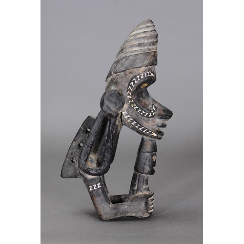 1123 - NGUZU NGUZU CANOE PROW ORNAMENT, SOLOMON ISLANDS. Carved and engraved wood, black dye, nautilus shel... 