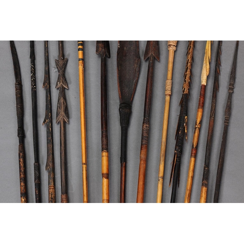 1148 - COLLECTION OF THIRTEEN EARLY MELANESIAN SPEARS. Carved and engraved wood, bone, bamboo, with natural... 