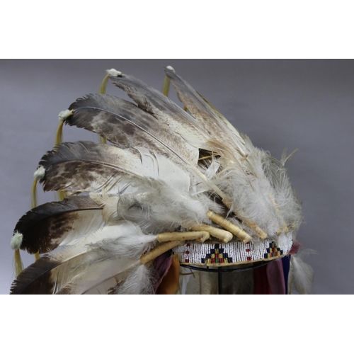 1185 - Magnificent rare Plains Indian single-trail headdress. Constructed with felt cap, front band of glas... 