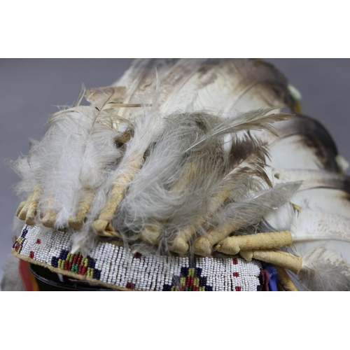 1185 - Magnificent rare Plains Indian single-trail headdress. Constructed with felt cap, front band of glas... 