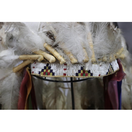 1185 - Magnificent rare Plains Indian single-trail headdress. Constructed with felt cap, front band of glas... 