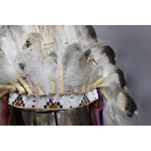 1185 - Magnificent rare Plains Indian single-trail headdress. Constructed with felt cap, front band of glas... 