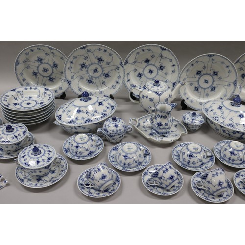 92 - Extensive Royal Copenhagen service. Blue fluted lace pattern, teapot has been repaired to lip, two l... 