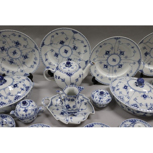 92 - Extensive Royal Copenhagen service. Blue fluted lace pattern, teapot has been repaired to lip, two l... 