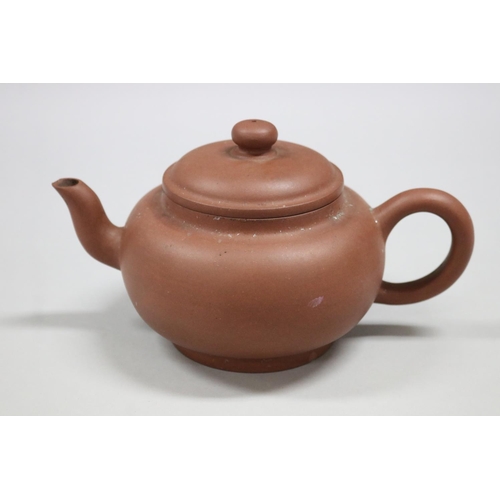 73 - Two Yixing Zhusha clay tea pots, one with raised painted decoration, the other of squat plain form, ... 