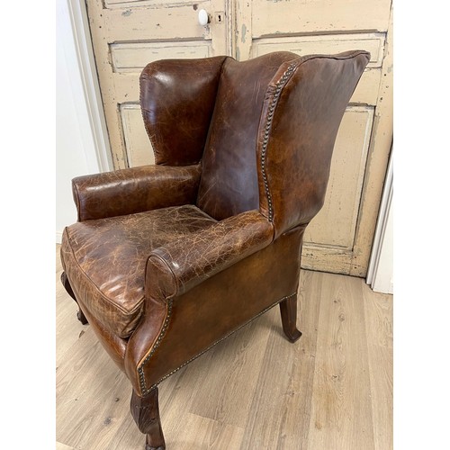 97 - Georgian style brown leather wing arm chair