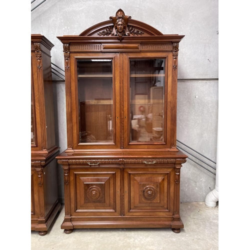 103 - Pair of French walnut two height bookcases, each with a carved in high relief female mask central ca... 