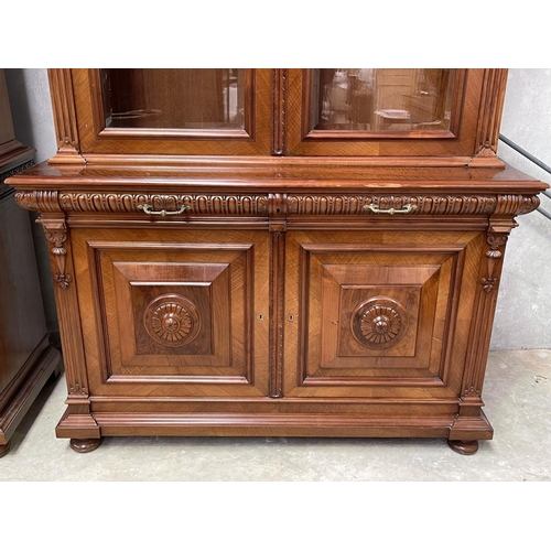 103 - Pair of French walnut two height bookcases, each with a carved in high relief female mask central ca... 