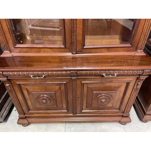 103 - Pair of French walnut two height bookcases, each with a carved in high relief female mask central ca... 