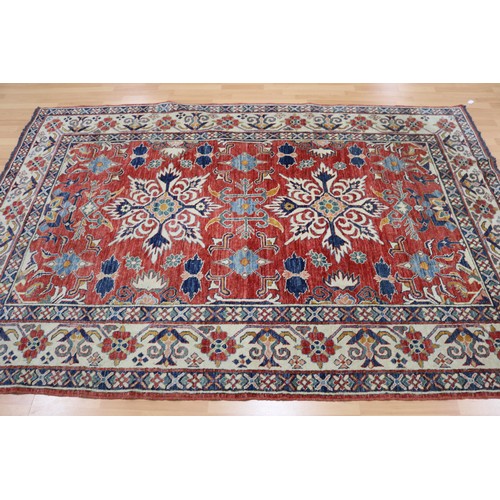 159 - Good Afghan hand knotted wool carpet, with ivory borders and central central red ground, with floral... 