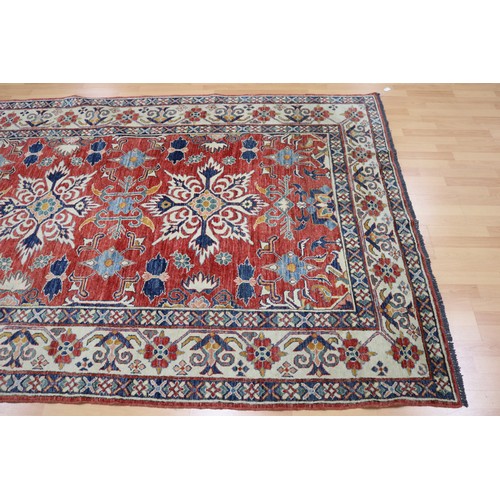 159 - Good Afghan hand knotted wool carpet, with ivory borders and central central red ground, with floral... 