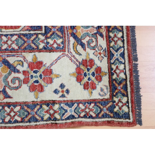 159 - Good Afghan hand knotted wool carpet, with ivory borders and central central red ground, with floral... 