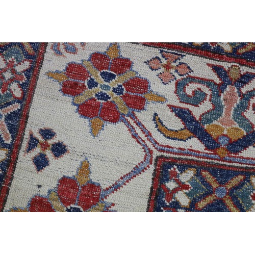 159 - Good Afghan hand knotted wool carpet, with ivory borders and central central red ground, with floral... 