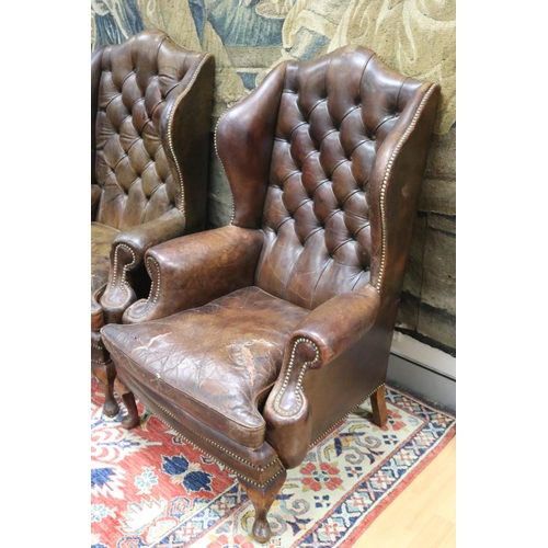 84 - Pair of vintage Georgian revival studded brown leather wing arm chairs, cushions distressed conditio... 