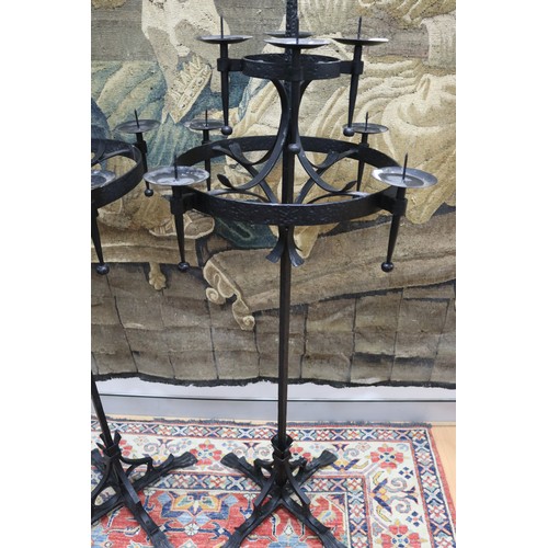 100 - Large pair of wrought iron gothic revival nine stick floor standing pickets, each of two tiered desi... 