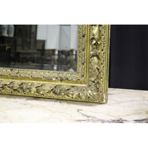 139 - Large gilt gesso framed mirror, with bevelled plate mirror, the frame moulded in high relief fruitin... 