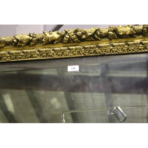 139 - Large gilt gesso framed mirror, with bevelled plate mirror, the frame moulded in high relief fruitin... 