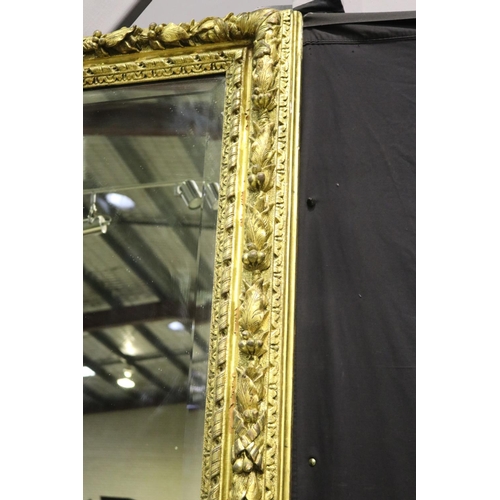 139 - Large gilt gesso framed mirror, with bevelled plate mirror, the frame moulded in high relief fruitin... 