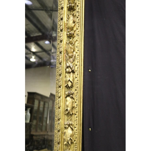 139 - Large gilt gesso framed mirror, with bevelled plate mirror, the frame moulded in high relief fruitin... 