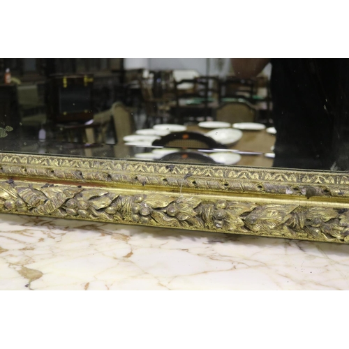 139 - Large gilt gesso framed mirror, with bevelled plate mirror, the frame moulded in high relief fruitin... 