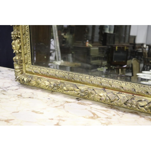 139 - Large gilt gesso framed mirror, with bevelled plate mirror, the frame moulded in high relief fruitin... 