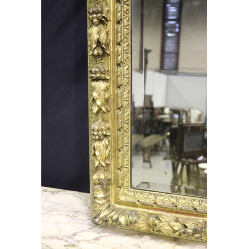 139 - Large gilt gesso framed mirror, with bevelled plate mirror, the frame moulded in high relief fruitin... 