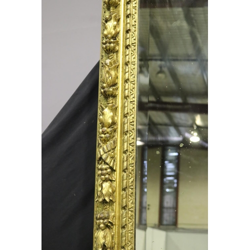 139 - Large gilt gesso framed mirror, with bevelled plate mirror, the frame moulded in high relief fruitin... 