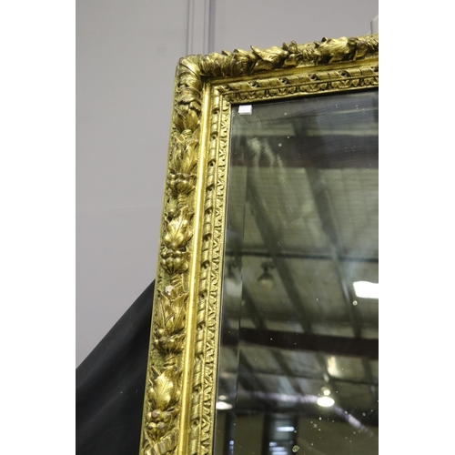 139 - Large gilt gesso framed mirror, with bevelled plate mirror, the frame moulded in high relief fruitin... 