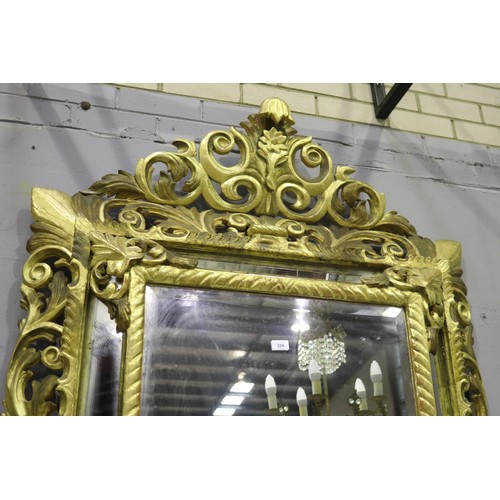 134 - Large antique 19th century French giltwood pierced surround cushion mirror, with central elaborate c... 