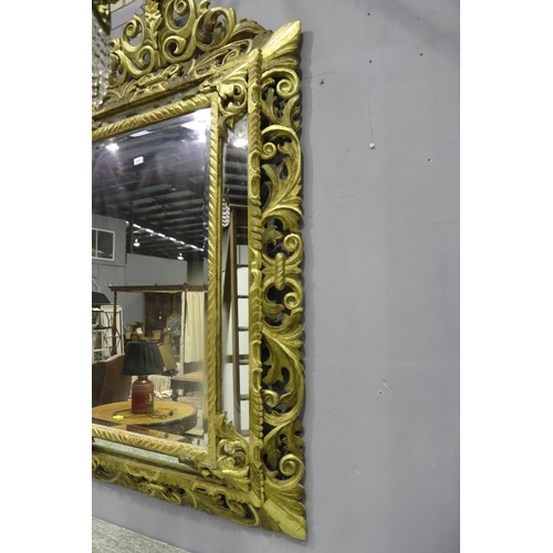 134 - Large antique 19th century French giltwood pierced surround cushion mirror, with central elaborate c... 