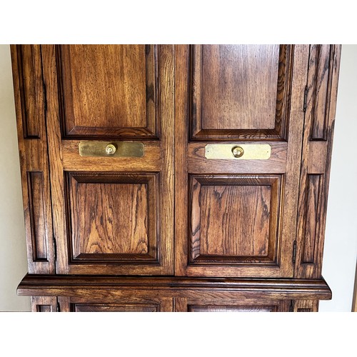 88 - Oak wardrobe with panel doors brass fitting pidgeon hole and drawer interior, approx 188cm H x 113cm... 