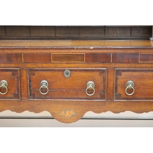 227 - Antique late 18th century oak and mahogany cross banded three drawer dresser, the open central shelf... 