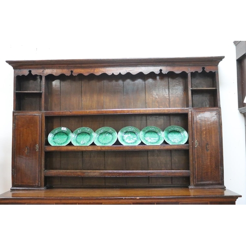 227 - Antique late 18th century oak and mahogany cross banded three drawer dresser, the open central shelf... 