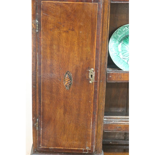 227 - Antique late 18th century oak and mahogany cross banded three drawer dresser, the open central shelf... 