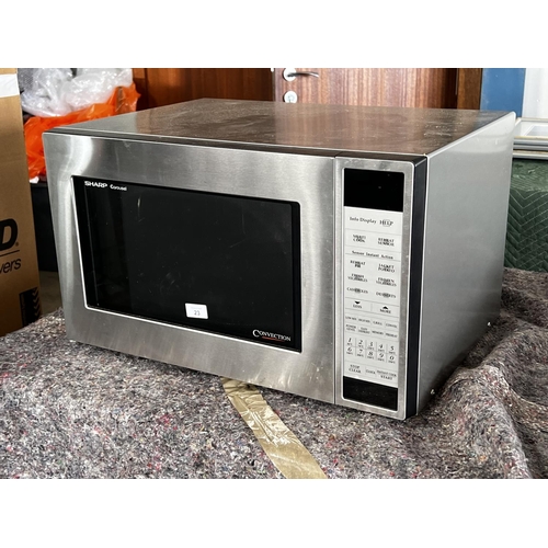 23 - Sharp carousel convection stainless steel microwave
no circular glass dish. working