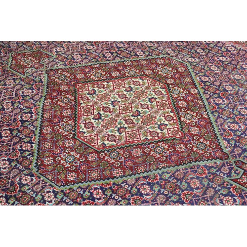 231 - Large Persian carpet of mostly red ground, approx 293cm x 370cm