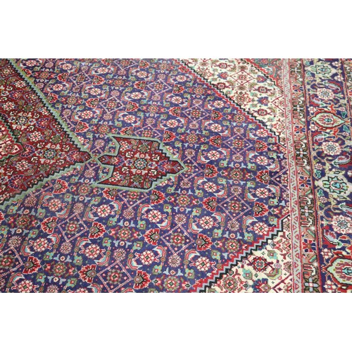 231 - Large Persian carpet of mostly red ground, approx 293cm x 370cm