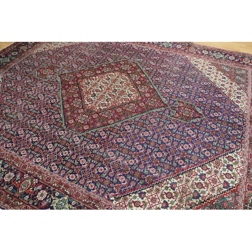 231 - Large Persian carpet of mostly red ground, approx 293cm x 370cm