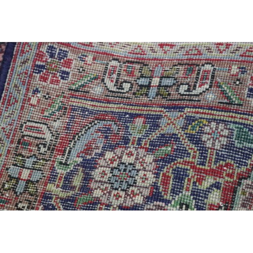 231 - Large Persian carpet of mostly red ground, approx 293cm x 370cm