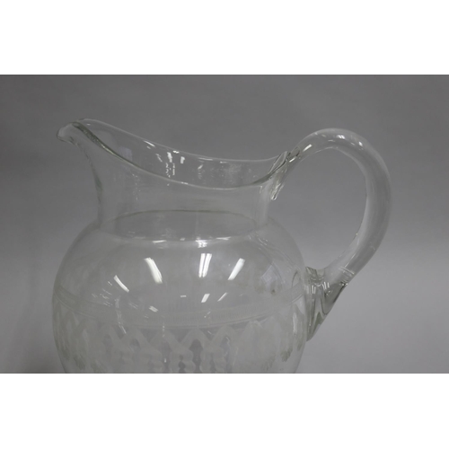 49 - Large antique glass jug, with central band of engraved decoration, applied loop handle, ground ponte... 