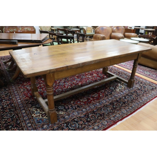 287 - English oak slab top period revival trestle table, with central long stretcher, held by turned block... 