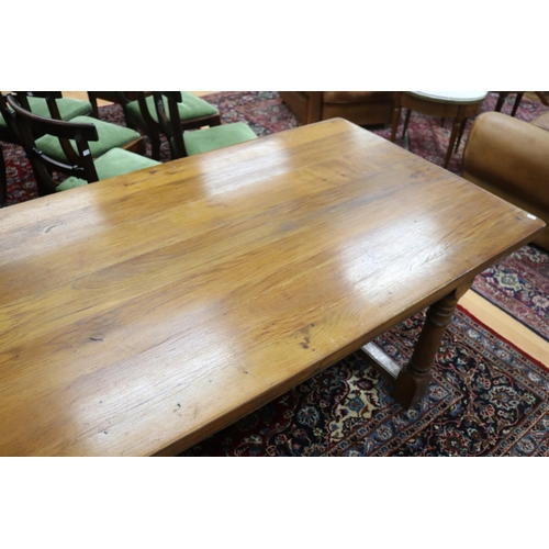 287 - English oak slab top period revival trestle table, with central long stretcher, held by turned block... 