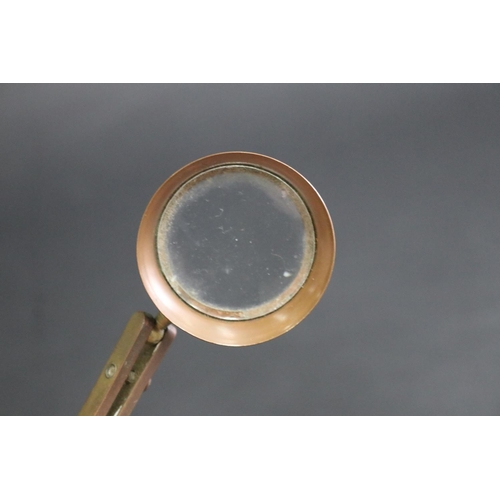 335 - Magnifying glass on stand, approx 10cm H