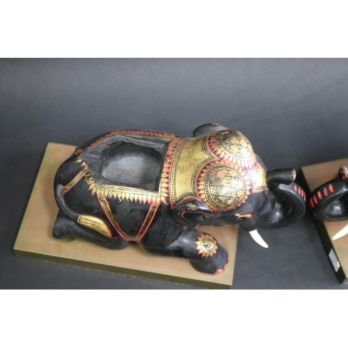 342 - Pair of carved wood & painted elephants on brass stands, each approx 18cm H x 27cm W x 15cm D (2)